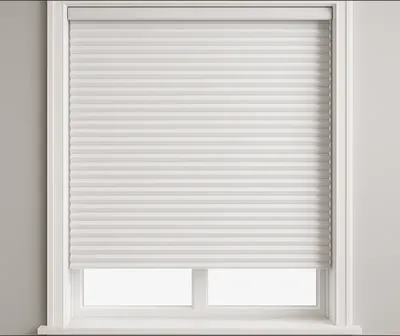 White honeycomb blind fitted in a white-framed window