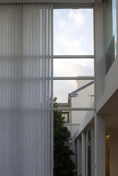 Pale vertical blinds beside a tall window