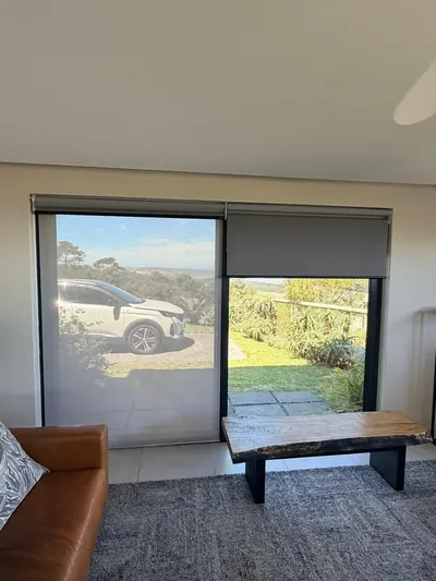 Duo roller with sheer layer lowered on living room sliding doors, grey blockout above