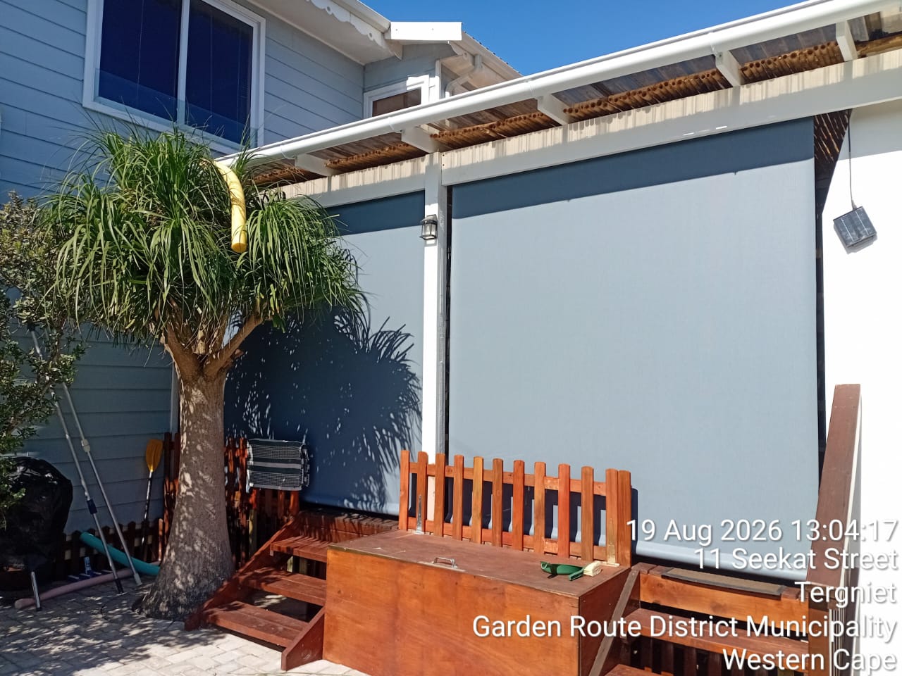 Custom Blinds Grey screen outdoor blinds enclosing a residential patio in South Africa