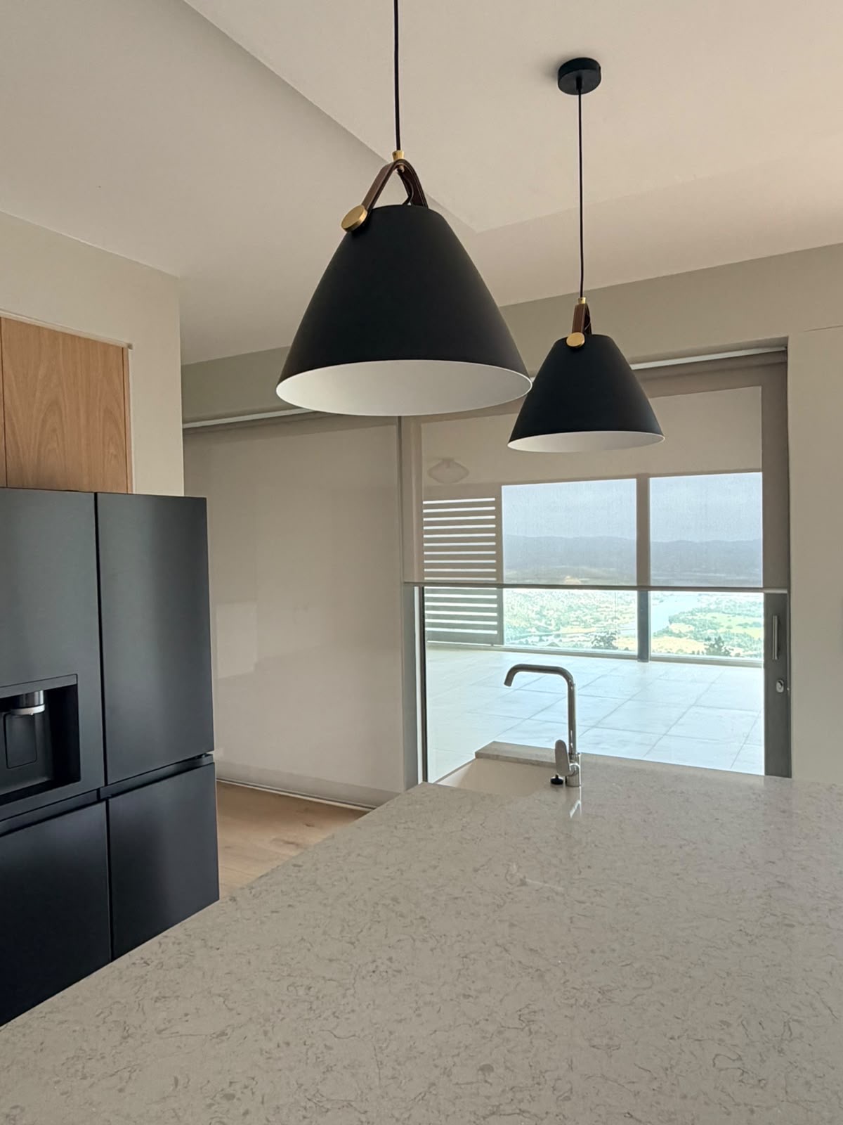 Dune Grey sheer roller blind on kitchen sliding door high-rise view