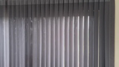 Close-up of grey semi-sheer vertical blinds