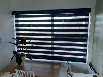 Navy zebra double roller blind on a study window